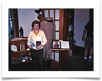 Raqui holding Ed's book and DVD of Never Surrender in the Cavalry Museum